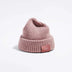 Våga Midweight Beanie in pink – angled front view with Våga label