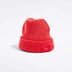 Våga Midweight Beanie in orange-red – angled front view with Våga label